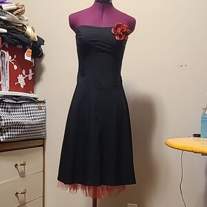 Elegant Black Strapless Dress with Red Flower Accent